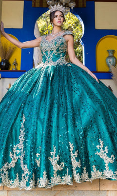 A woman in the Quinceanera Ball Gown 8024J, featuring gold lace embroidery and glitter tulle, stands before a vibrant background, wearing a jeweled crown.