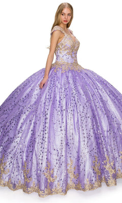 A young woman wears the Quinceanera Ball Gown 8024J—a voluminous lavender dress with glitter tulle and gold lace embroidery—standing against a white background.