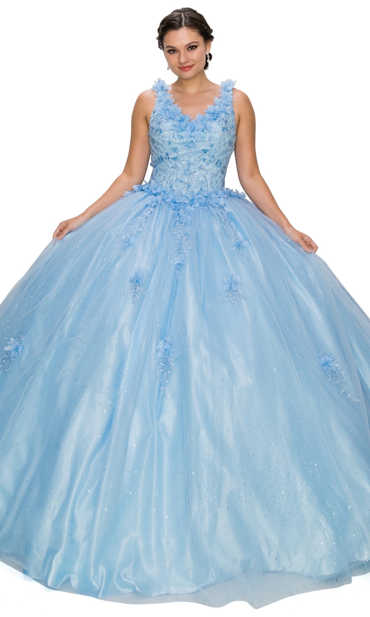 A woman wears the Quinceanera Ball Gown 8025J, a light blue dress with a fitted floral bodice and voluminous glitter tulle skirt, standing against a white background.