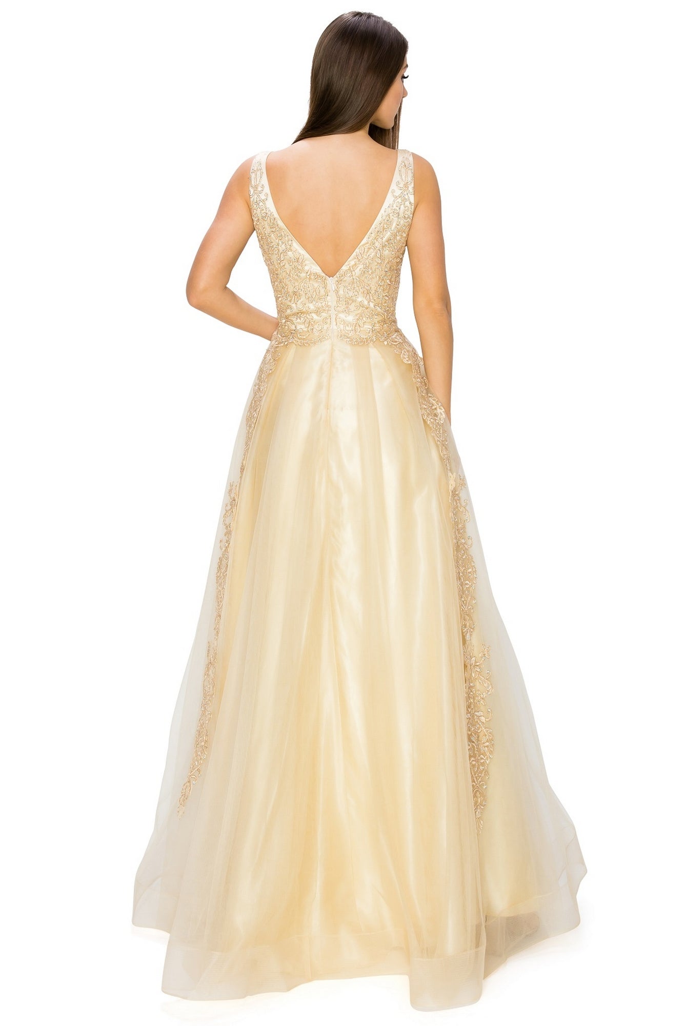 A woman stands facing away, wearing the A-Line Gold-Embroidered Long Prom Ball Gown 8029J—a floor-length, sleeveless gold dress with a deep V-back and delicate lace detailing.