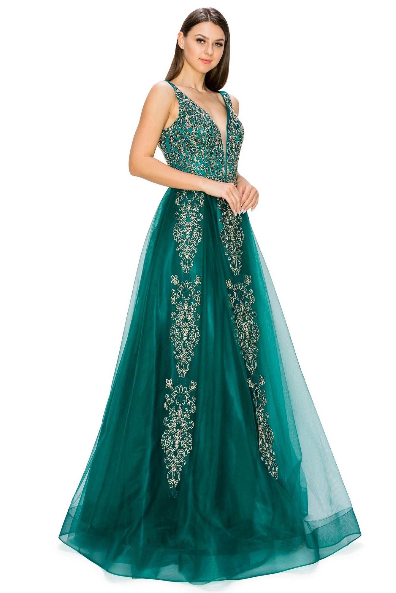 A woman in the A-Line Gold-Embroidered Long Prom Ball Gown 8029J, an affordable sleeveless emerald green dress with a deep V-neck, gold embroidery, and floor-length tulle skirt, stands against a white background.