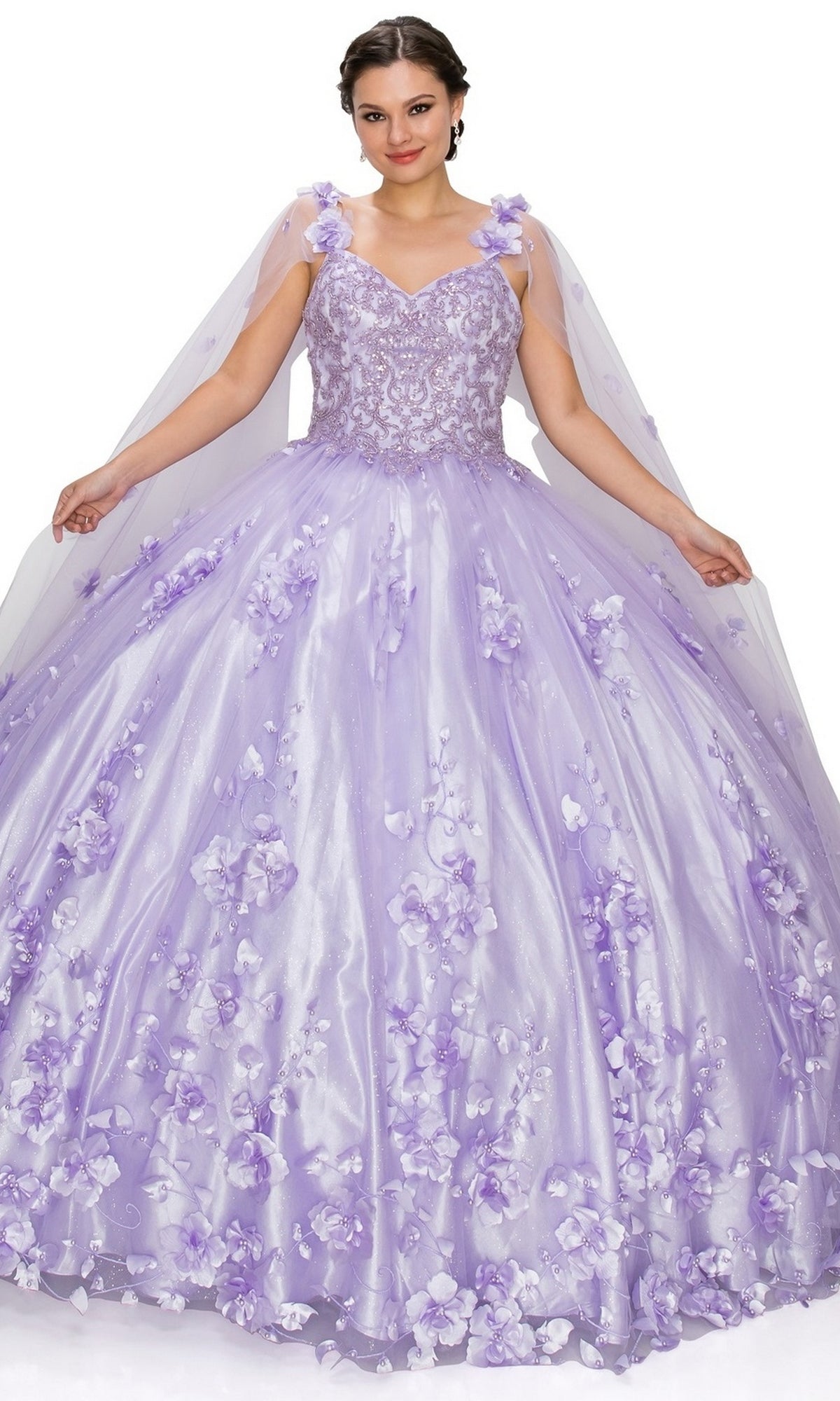 A woman wearing the Quinceanera Ball Gown 8030J in light purple with 3D floral embellishments holds out her skirt and smiles at the camera against a white background.