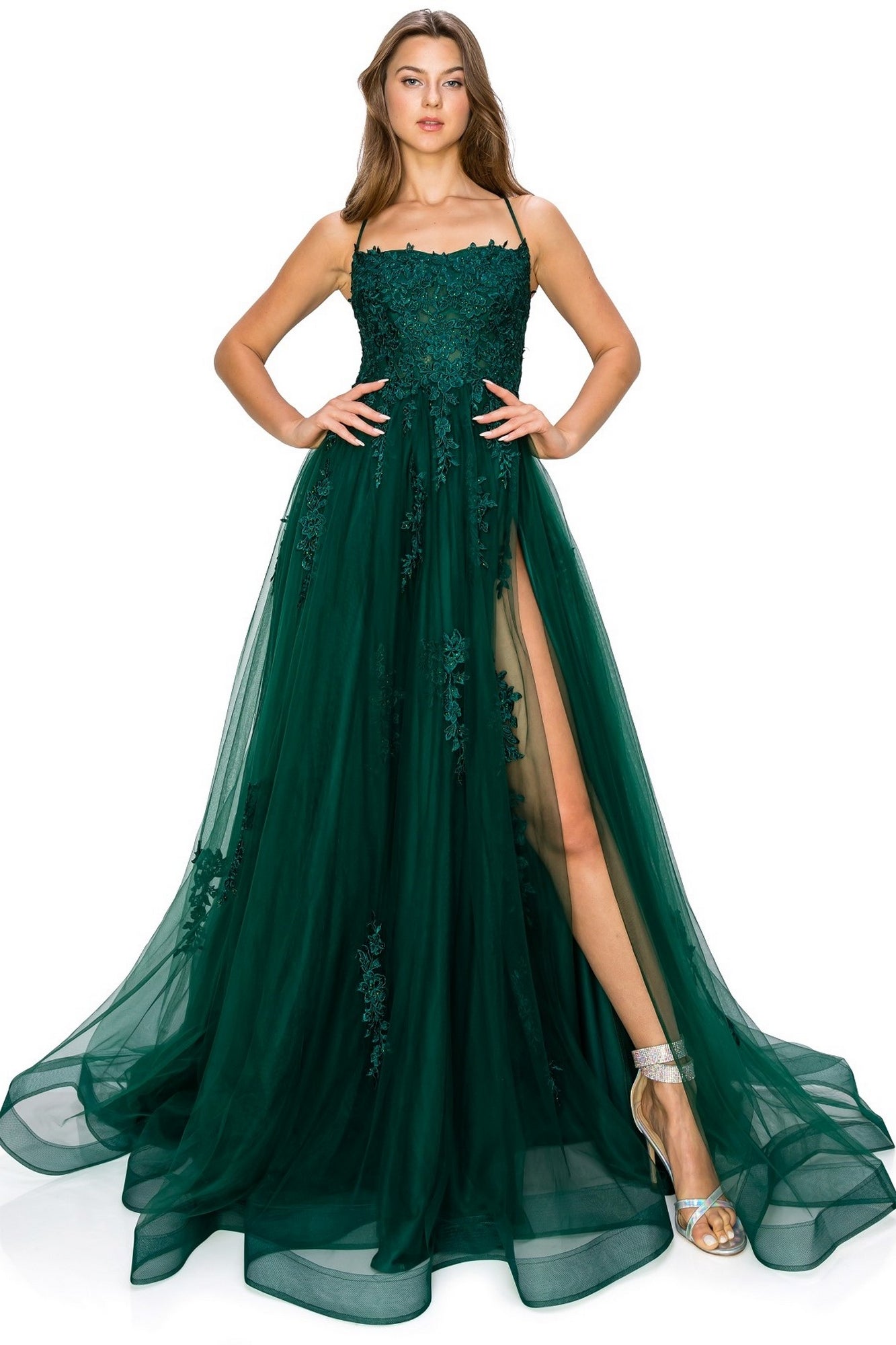 A woman wearing the Floral-Embroidered Long Tulle Prom Dress 8031J, a dark green, floor-length formal dress with lace detailing, floral embroidery, and a high slit, paired with silver high-heeled sandals.