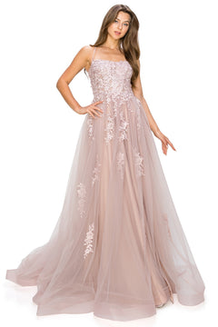 A woman stands with one hand on her hip, wearing the Floral-Embroidered Long Tulle Prom Dress 8031J—a blush pink, floor-length gown with floral embroidery and lace appliqué on the bodice and skirt.