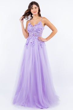 A woman stands smiling against a plain white background, wearing the Sheer-Bodice Long A-Line Prom Ball Gown 8038J with 3D floral accents and a flowing tulle skirt.