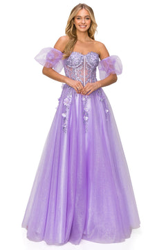A woman wears the Puff-Sleeve Long Sweetheart Prom Ball Gown 8042J—a sparkly, lavender off-the-shoulder dress with floral appliqué and sheer puff sleeves, perfect for prom or any formal event.