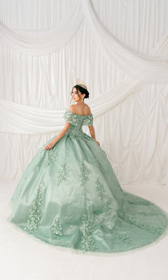 A woman in the Quinceanera Ball Gown 8045J with off-the-shoulder 3D floral detail and a tiara stands facing away from the camera before white draped fabric.