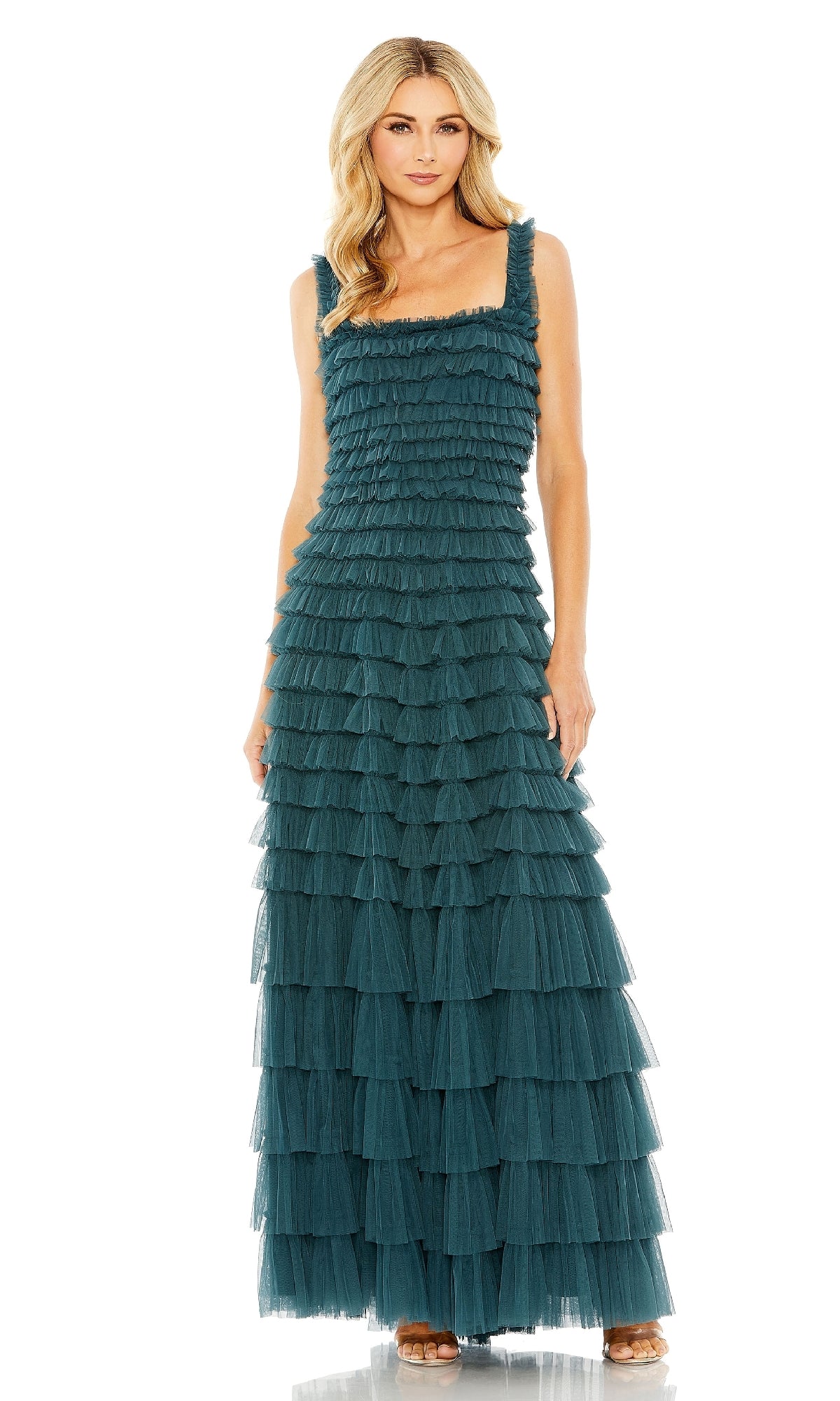 A woman wears the Teal Long Ruffled Prom Dress: Mac Duggal 8046, a sleeveless, floor-length gown featuring layered ruffles and a square neckline, paired with open-toed heels.