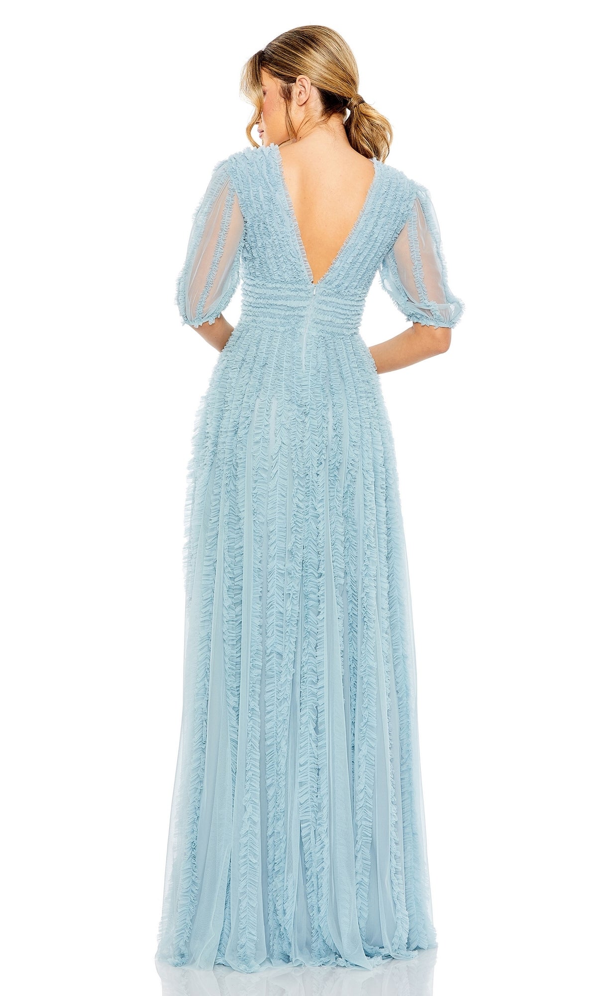 Woman wearing the Long Formal Dress 8050 by Mac Duggal—a light blue, floor-length A-line gown with sheer puff sleeves and a deep V-back—standing and facing away from the camera.