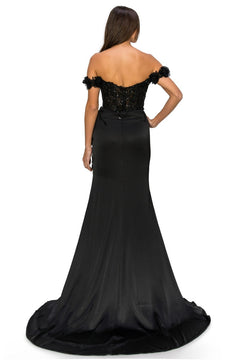 A woman stands facing away, wearing the Off-the-Shoulder Floral Embroidered Prom Dress 8050J, featuring a fitted bodice and a long, flared train.