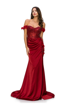 A woman models the Off-the-Shoulder Floral Embroidered Prom Dress 8050J, featuring red floor-length fabric, beaded floral appliqués, and a fitted embellished bodice, standing against a white background.