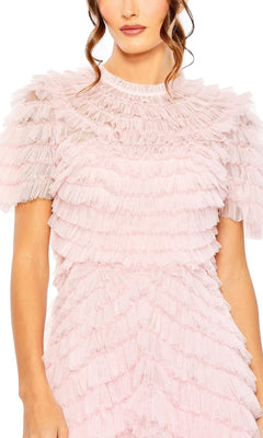 A woman wearing the Mac Duggal Midi Wedding Guest Dress 8055 in light pink, featuring layered ruffles and short sleeves, shown from shoulders to mid-thigh.