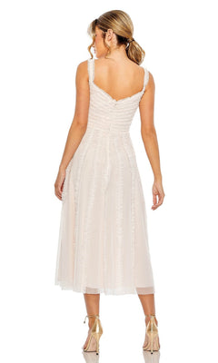 A woman faces away, wearing the Mac Duggal 8056 Ruffled Midi Wedding Guest Dress—a light-colored, semi-formal party dress with a fitted bodice and flared skirt—paired with nude high-heeled shoes.