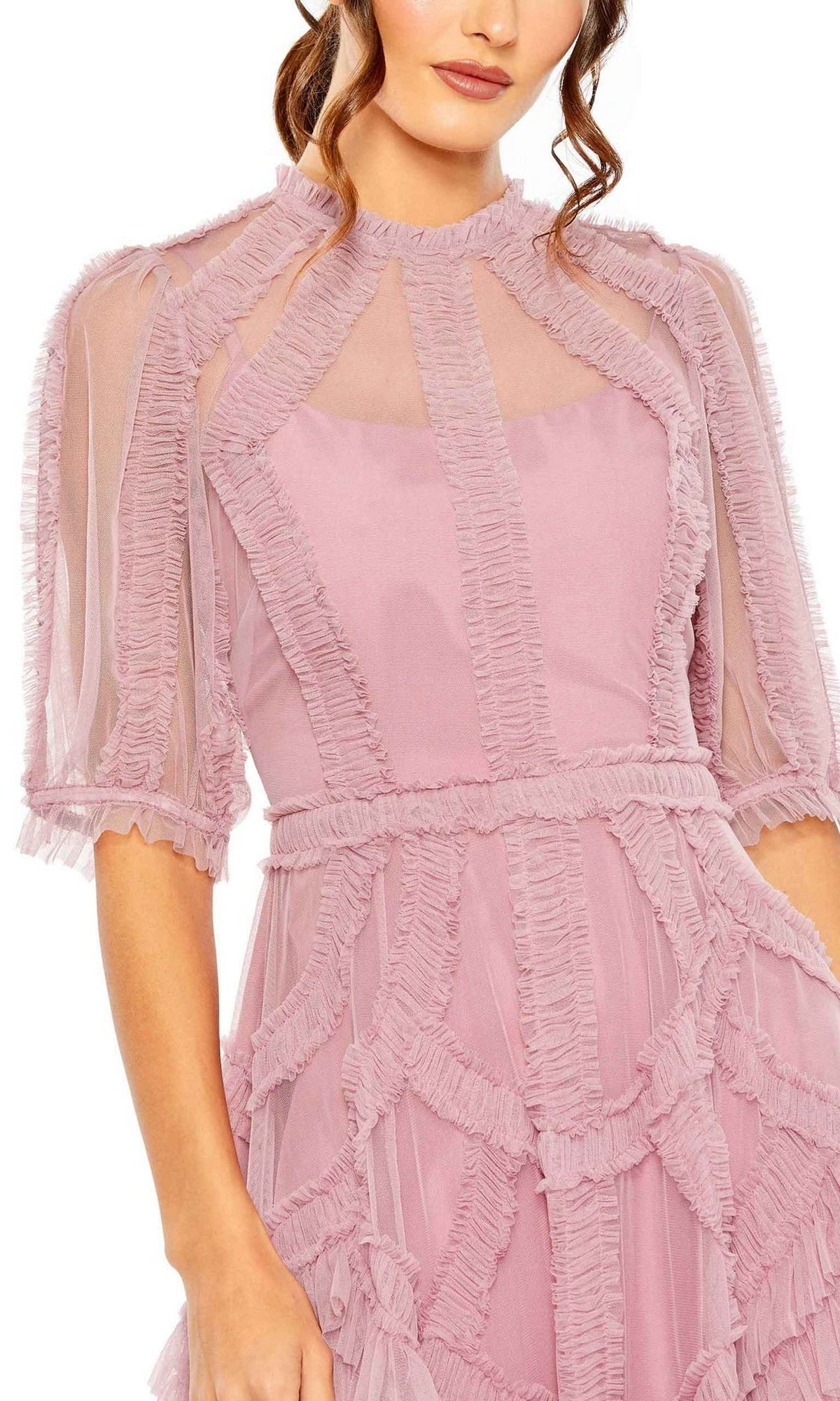 A woman models the Mac Duggal 8058 Ruffled Midi Wedding-Guest Dress in light pink, featuring sheer ruffled panels and short sleeves, photographed from shoulders to mid-thigh against a white background.