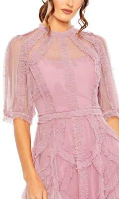 A woman models the Mac Duggal 8058 Ruffled Midi Wedding-Guest Dress in light pink, featuring sheer ruffled panels and short sleeves, photographed from shoulders to mid-thigh against a white background.