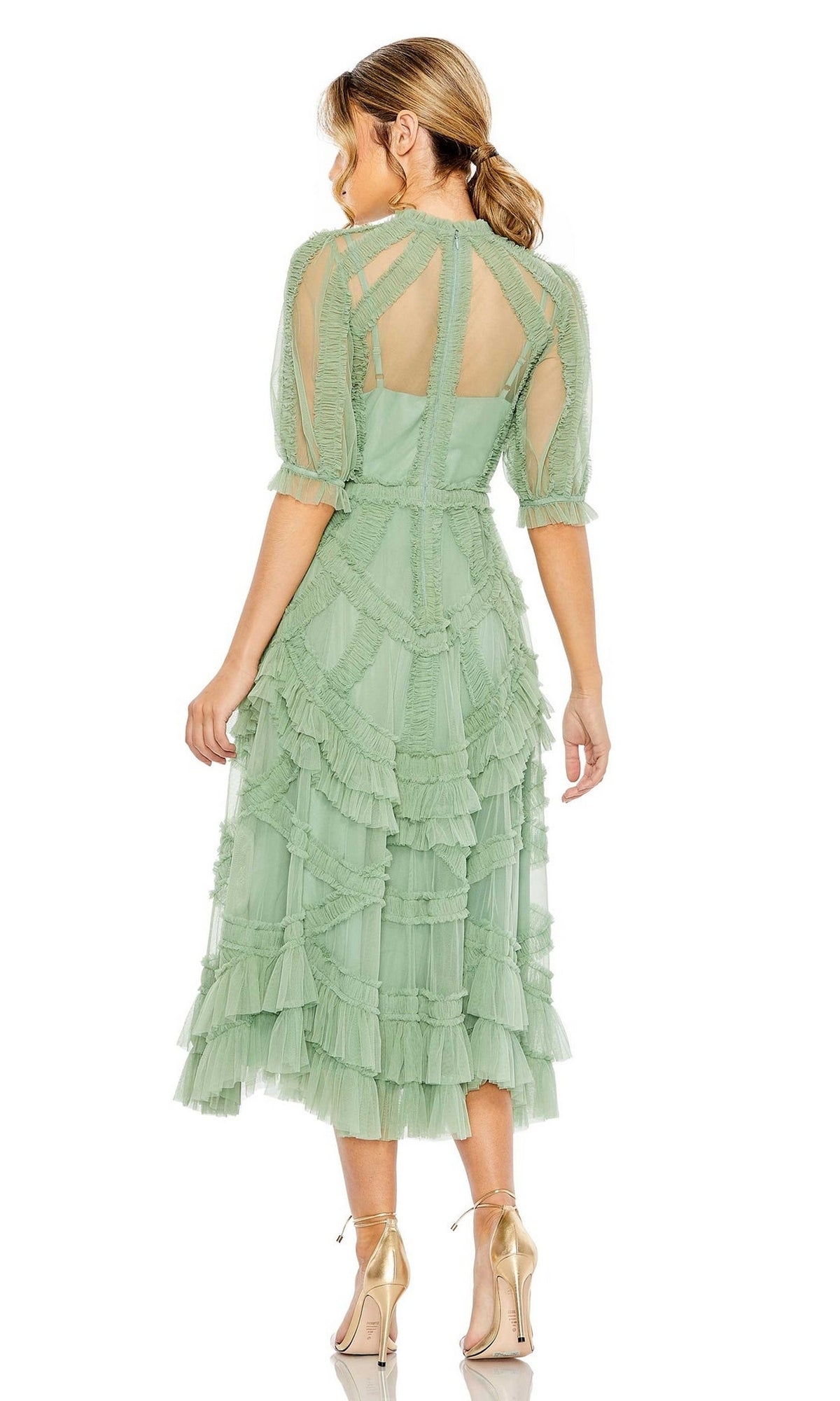 Woman faces away wearing the Mac Duggal 8058 Ruffled Midi Wedding-Guest Dress in light green, featuring ruffles, sheer sleeves, and a back cutout, paired with gold high heels.