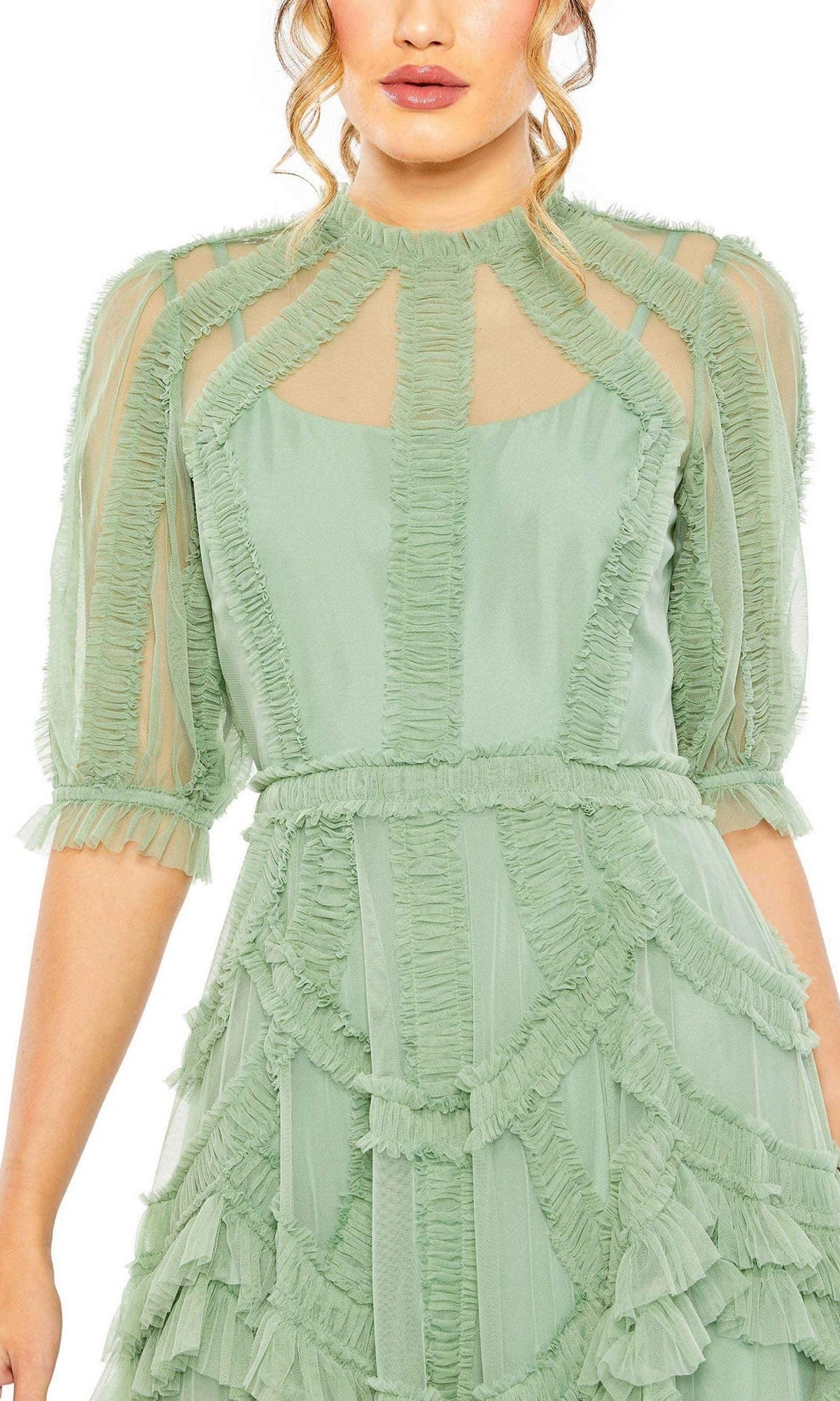 Woman wearing the Mac Duggal 8058 Ruffled Midi Wedding-Guest Dress in light green, featuring sheer sleeves and ruffle details, shown from shoulders to mid-thigh.
