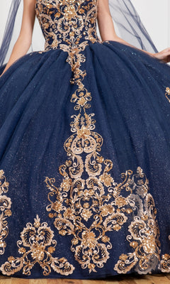 Someone wearing the Quinceanera Ball Gown 8063J, featuring dark blue fabric, gold embroidery, sparkling accents, and layered glitter tulle.