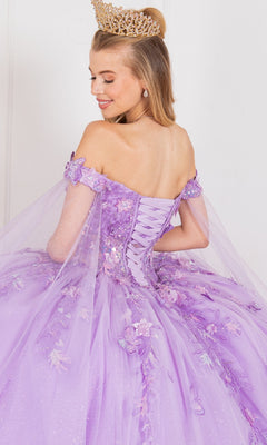 A woman faces backward, looking over her shoulder in a sparkly lavender Cinderella Couture 8075J off-the-shoulder quinceanera dress with floral 3D appliques and a gold crown.