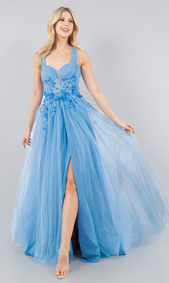 A woman models the Cinderella Couture 8076J, a long halter prom dress in light blue with floral appliqués, sheer overlay, and front slit, standing against a plain background.