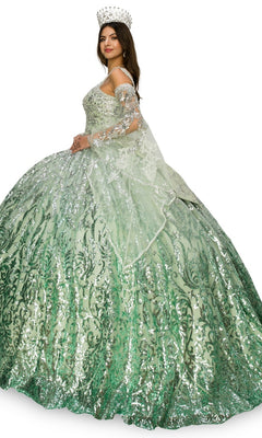 A woman models the Quinceanera Ball Gown 8080J, a sparkling green ombre dress with a full skirt and sheer shawl, finished with a jeweled crown as she stands slightly to the side.