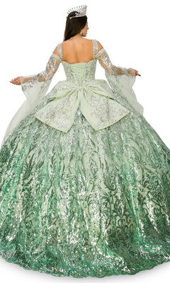 A woman, shown from the back with arms slightly raised, wears the Quinceanera Ball Gown 8080J—a large green ombre ball gown adorned with silver sequins and a crown.