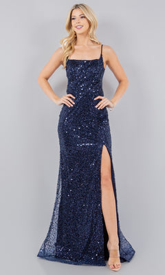 A woman models the Backless Sequin Prom Dress: Cinderella Couture 8081J, featuring navy blue sequins, spaghetti straps, and a thigh-high slit, as she stands against a plain gray background.