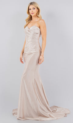 A woman models the Cinderella Couture 8083J, a strapless satin mermaid prom dress in floor-length champagne, against a plain light gray background.