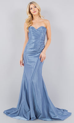 A woman stands against a plain light gray background wearing the Satin Mermaid Prom Dress: Cinderella Couture 8083J in light blue, featuring a strapless, fitted ruched bodice and a slight train.