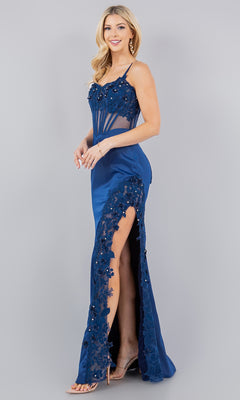 Woman standing and smiling in the Cinderella Couture 8085J Long Corset Prom Dress, a sleeveless blue gown with lace detailing, beaded embroidery, high slit, and strappy heels on a plain background.