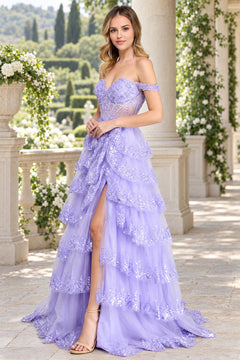 Amelia Couture 8085 lavender off-the-shoulder ball gown featuring lace appliques, a sequined tiered skirt, and a high slit.