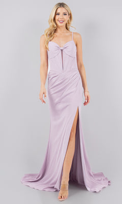 A woman wears the Pleated Corset Prom Dress: Cinderella Couture 8090J, a light lavender, floor-length gown with a sweetheart neckline, spaghetti straps, fitted bodice, and front slit, standing against a plain gray background.