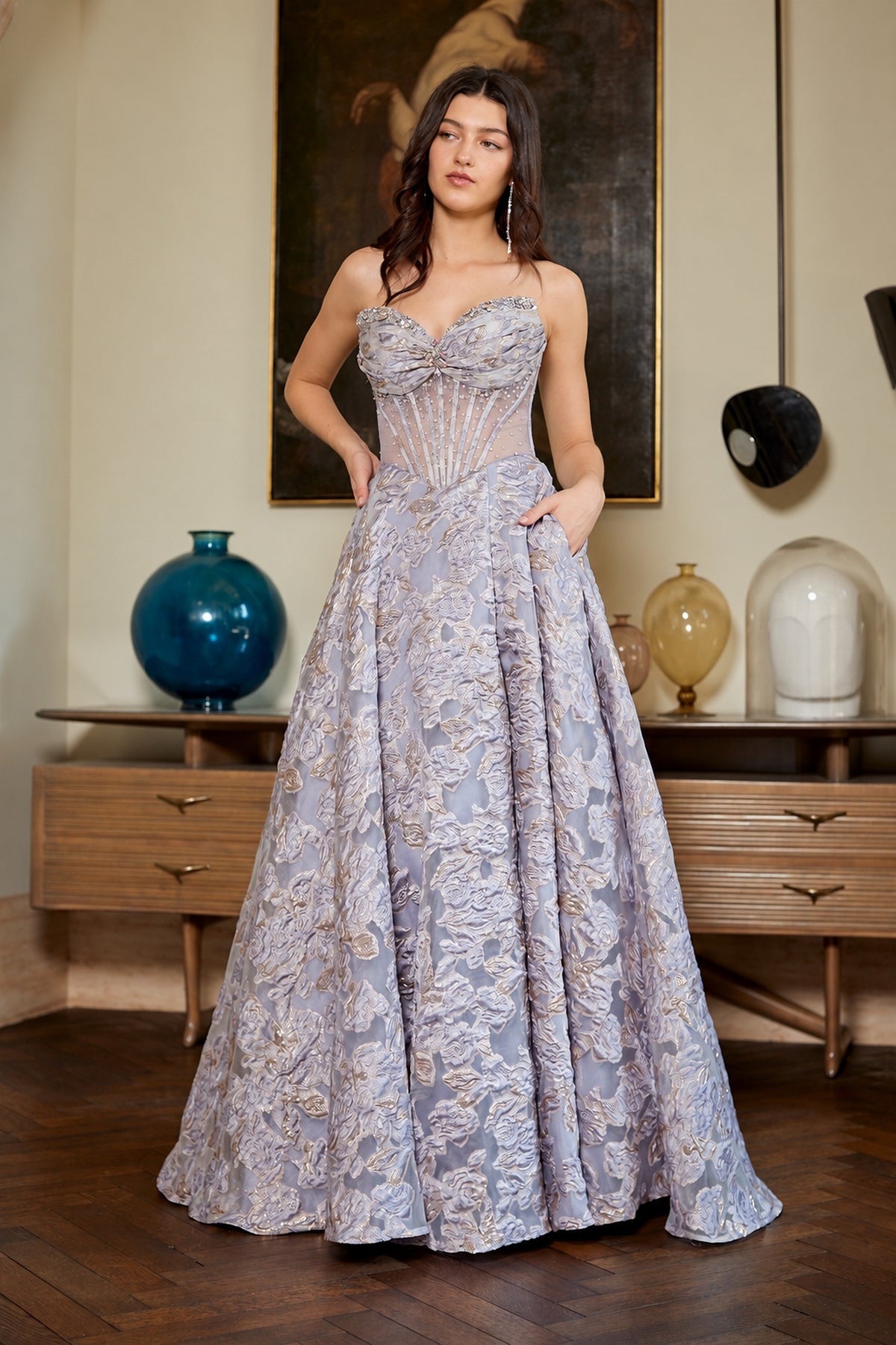 Amelia Couture 8098 is a strapless, floor-length floral prom dress with a sweetheart corset bodice and a full, textured skirt.