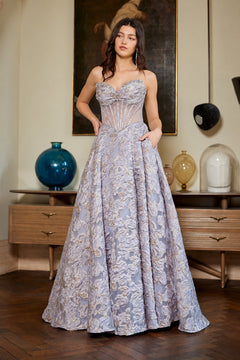 Amelia Couture 8098 is a strapless, floor-length floral prom dress with a sweetheart corset bodice and a full, textured skirt.