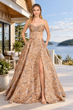 Amelia Couture 8098 strapless, floor-length floral prom dress with a sweetheart neckline, corset bodice, and a skirt featuring a high leg slit.