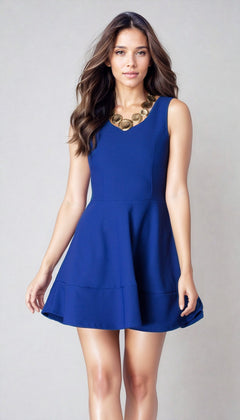 A woman models the Cheryl Creations Short Simple Homecoming Dress 2399—a sleeveless royal blue semi-formal dress—paired with a chunky gold necklace, standing against a plain light background.