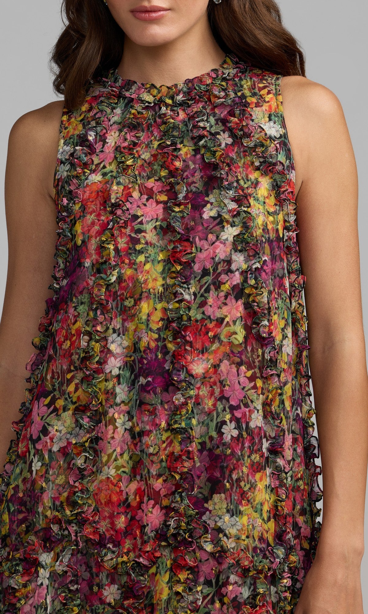 A woman wears the Mac Duggal 8103 Midi Floral Wedding Guest Dress, a sleeveless midi with multicolored floral pattern and textured ruffled details.