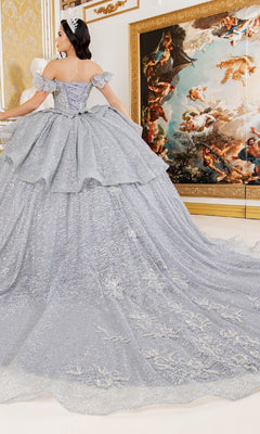 Wearing the Quinceanera Ball Gown 8120J, a woman stands in an ornate room adorned with gold accents and a large classical painting.