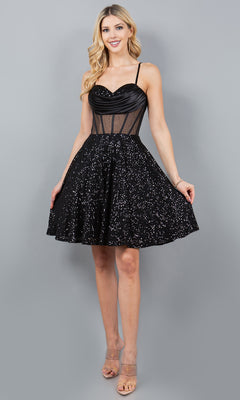 A woman models the Cowl-Neck Short Sequin Homecoming Dress 8126J, featuring a sleeveless design with a sparkling skirt and sheer corset bodice, standing against a plain gray backdrop.