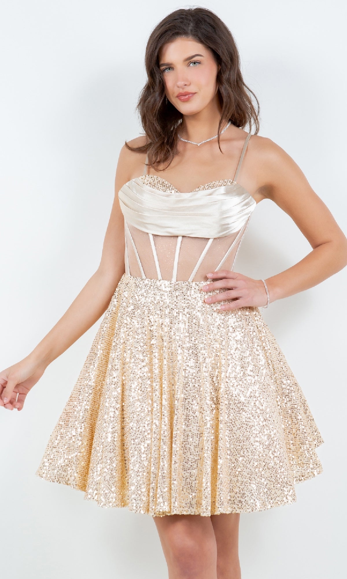 Woman wearing the Cowl-Neck Short Sequin Homecoming Dress 8126J—sleeveless, gold, fitted bodice with sheer mesh panels and flared skirt—standing against a plain white background.