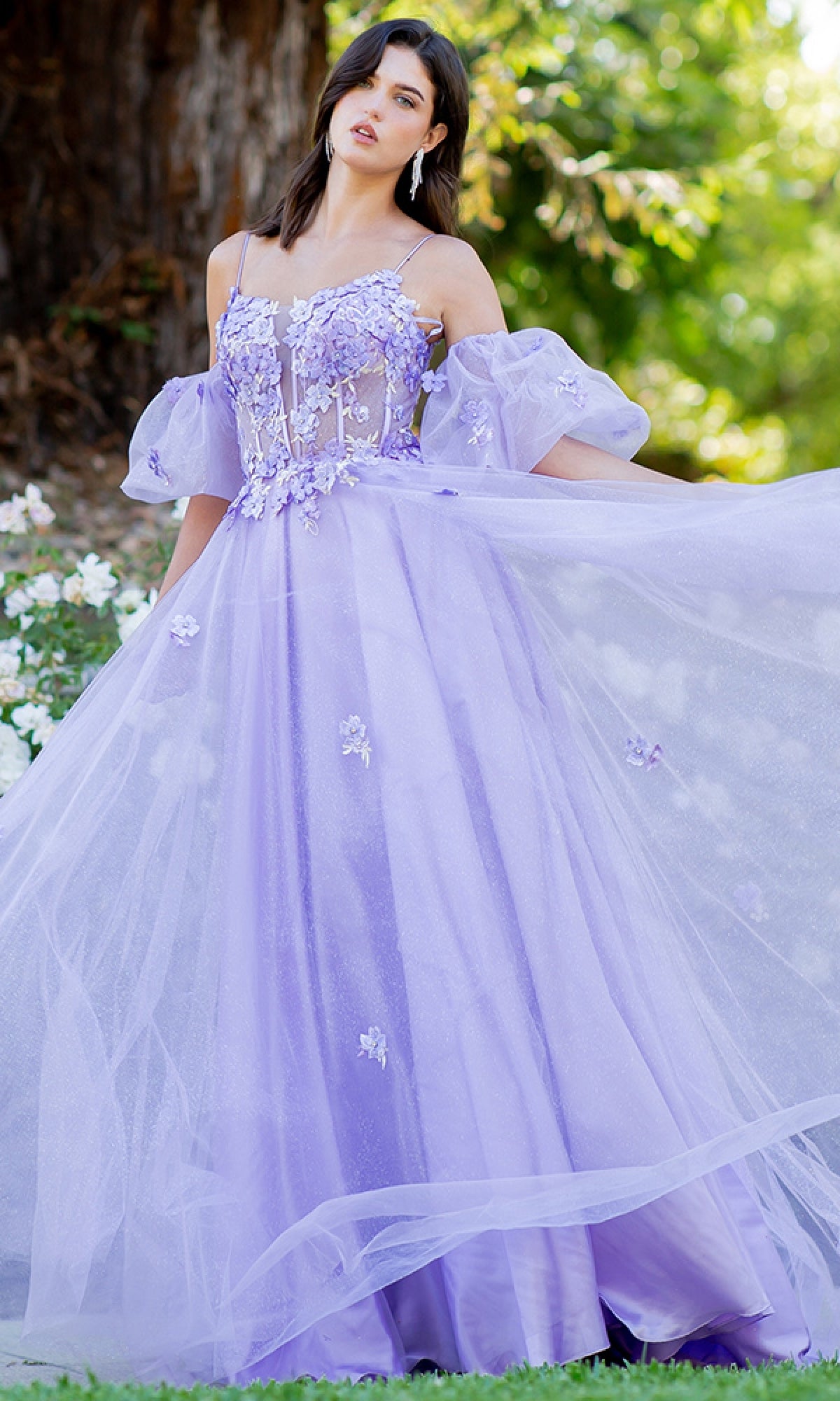 Outdoors, a woman wears the Purple Prom Ball Gown: Cinderella Couture 8130J—a lilac A-line dress with sheer puff sleeves and floral embellishments for an elegant prom look.