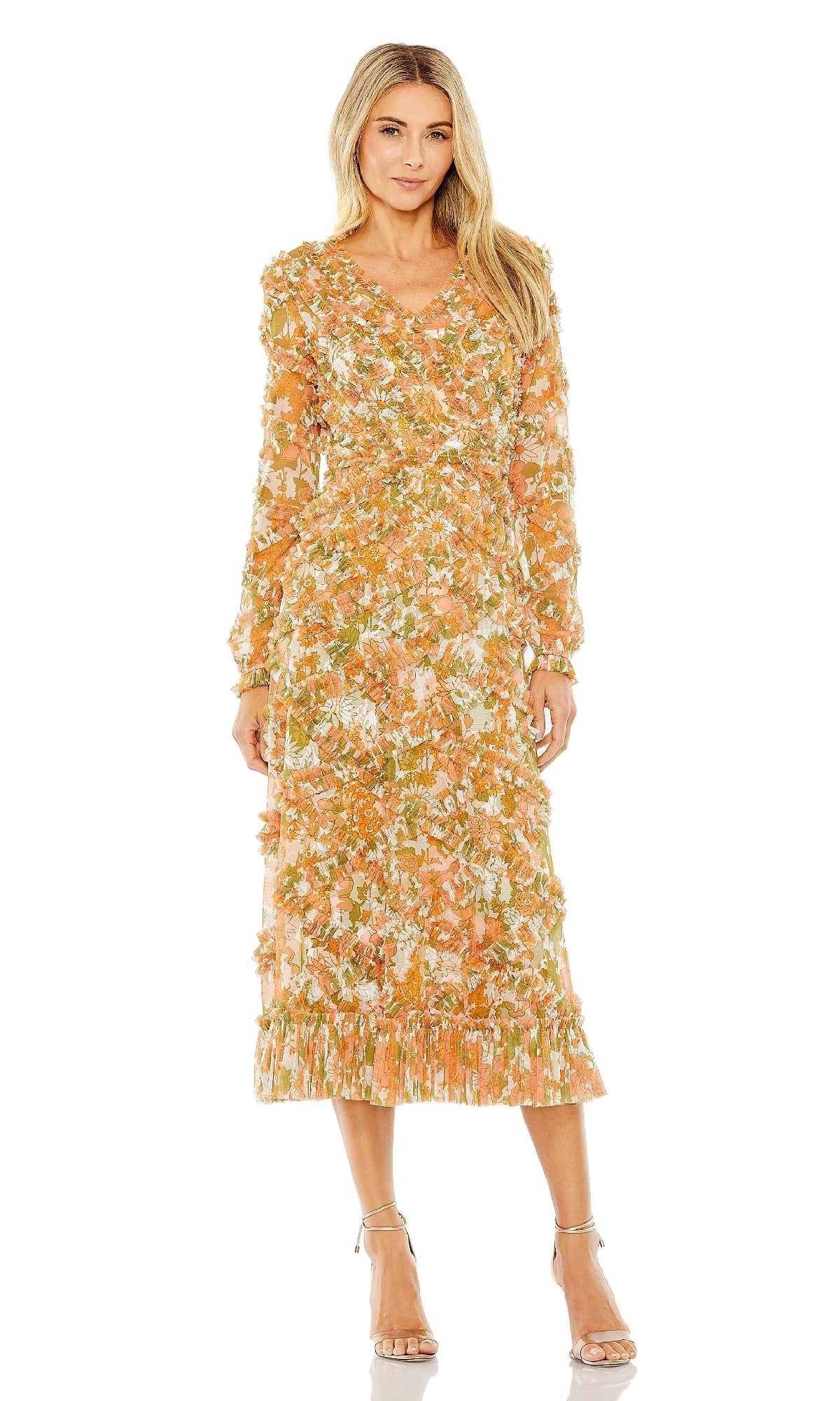 A woman wears the Mac Duggal 8134 Orange Print Wedding Guest Dress, featuring a floral-print midi length, long sleeves, and ruffle accents, paired with beige strappy heels—perfect for an elegant wedding guest look.