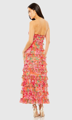 Woman wearing a colorful floral dress on a white background