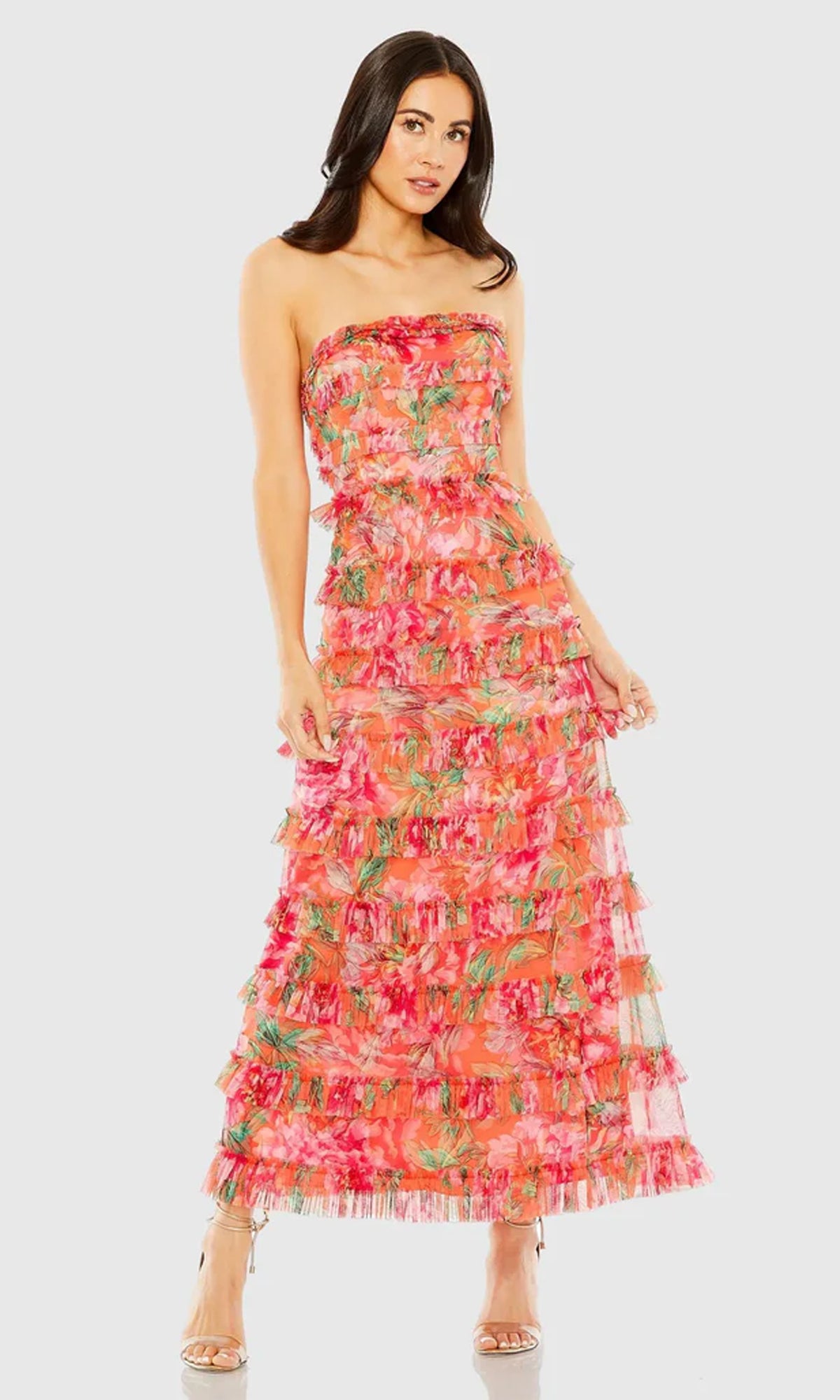 Woman wearing a strapless floral dress on a white background