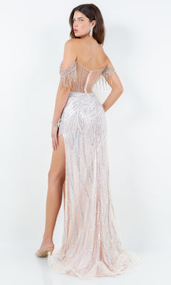 Woman wearing the Cinderella Couture 8147J, a long beaded prom dress with silver sequins, fringe detailing, off-the-shoulder design, high slit, and sheer panels, standing with her back to the camera.