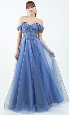A woman stands against a white background wearing the Cinderella Couture 8152J long prom ball gown featuring blue off-the-shoulder lace and tulle details.