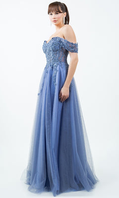 A woman models the Cinderella Couture 8152J Long Prom Ball Gown—an elegant blue off-the-shoulder dress with lace embroidery, a fitted bodice, and a flowing tulle skirt—against a plain white background.
