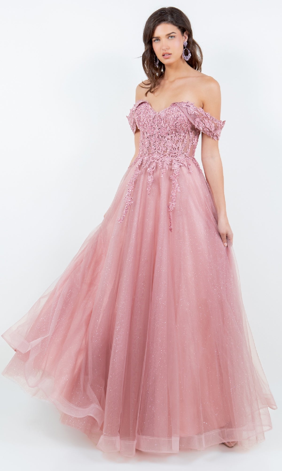 A woman stands against a plain white background wearing the Cinderella Couture 8152J, a floor-length, off-the-shoulder prom ball gown featuring embroidered-lace and sequin details.