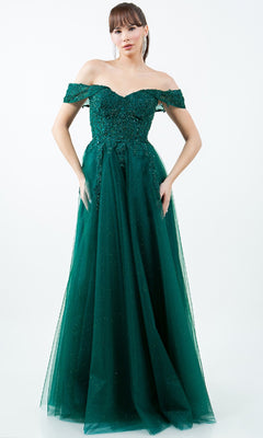 A woman poses against a white background in the Cinderella Couture 8152J—a long, off-shoulder emerald green prom ball gown with embroidered lace and sequin details.