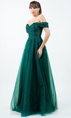 A woman wears the Cinderella Couture 8152J long prom ball gown in dark green, with an off-the-shoulder fitted bodice and flowing tulle skirt, standing against a plain white background.